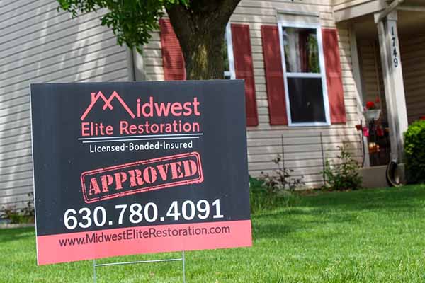 Midwest Elite Restoration yard sign in yard of clients